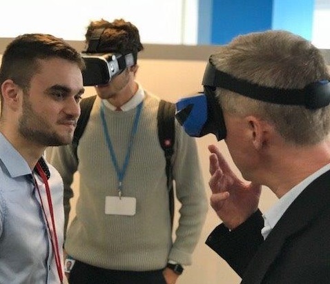 Two male volunteers wearing virtual reality masks